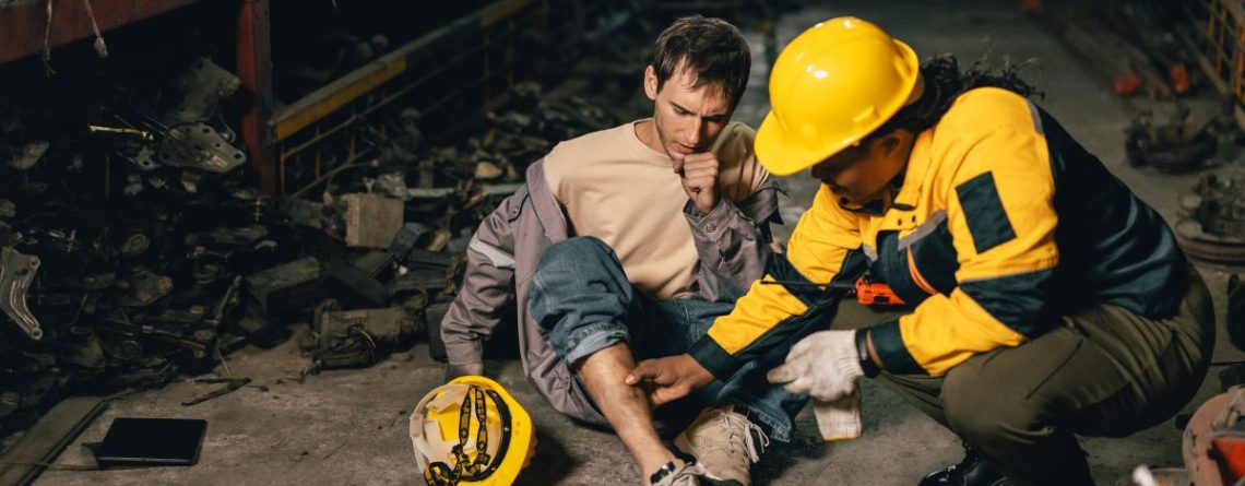 Coworker assisting an injured worker on a warehouse floor, WSIB decision did not stop human rights case for the employee.
