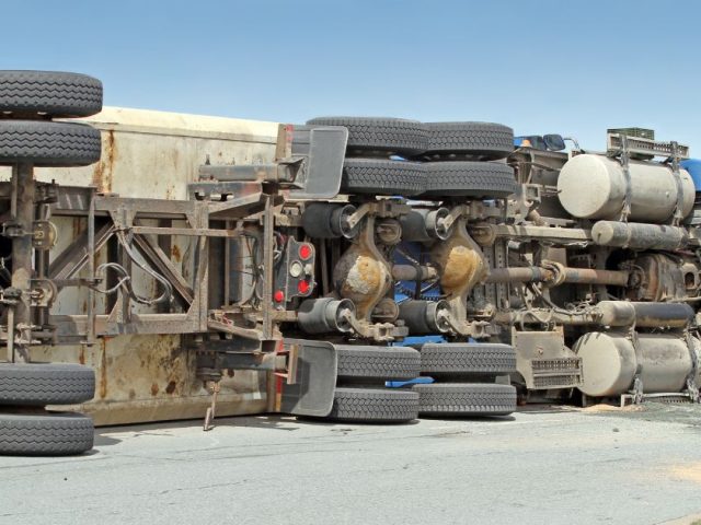 Overturned commercial truck on a roadway, medical expenses and WorkSafeBC claims for injured workers across British Columbia.