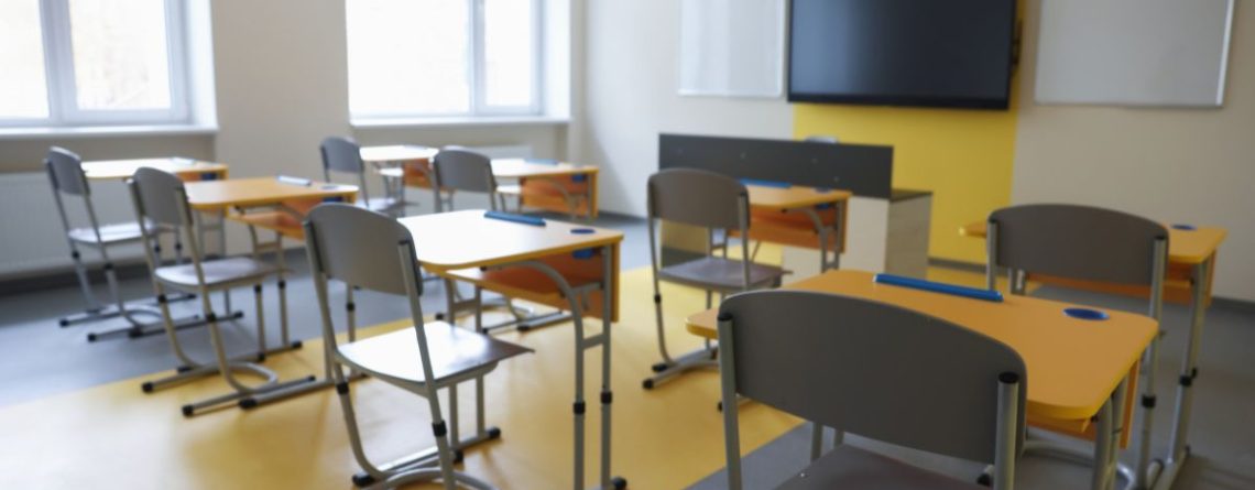 Empty classroom with desks illustrating HRTO ruling that employers need only provide reasonable accommodation in interviews, not perfection.