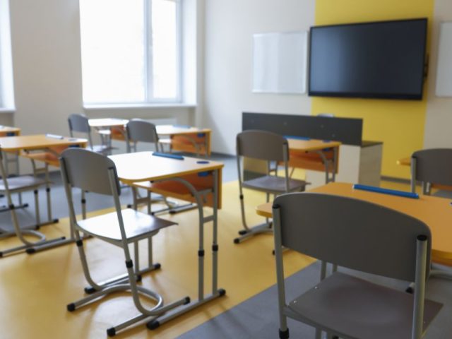 Empty classroom with desks illustrating HRTO ruling that employers need only provide reasonable accommodation in interviews, not perfection.