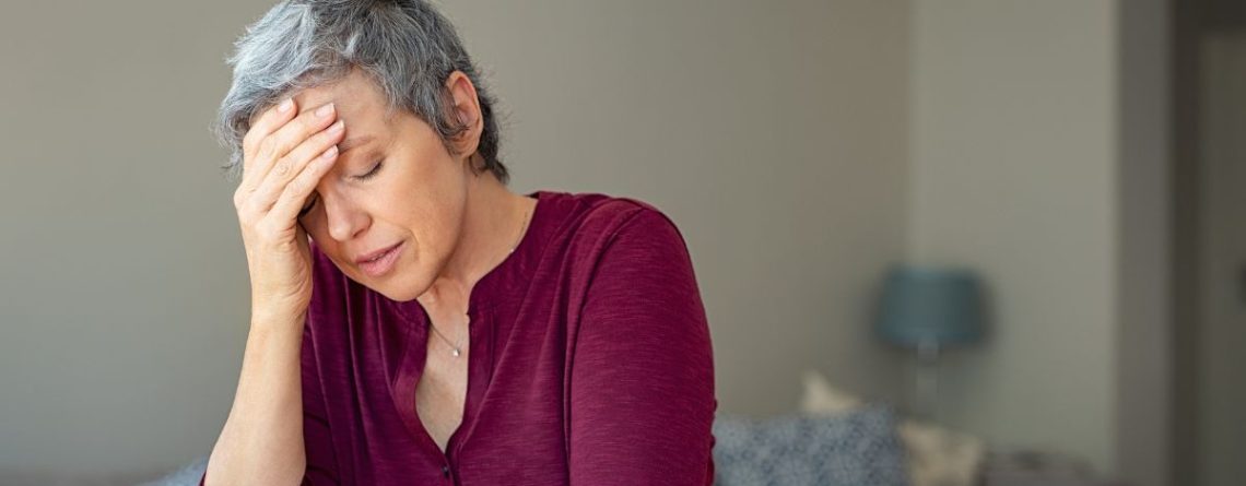 Distressed woman at home reflecting on what BC employees should know before responding to their employer in workplace disputes.
