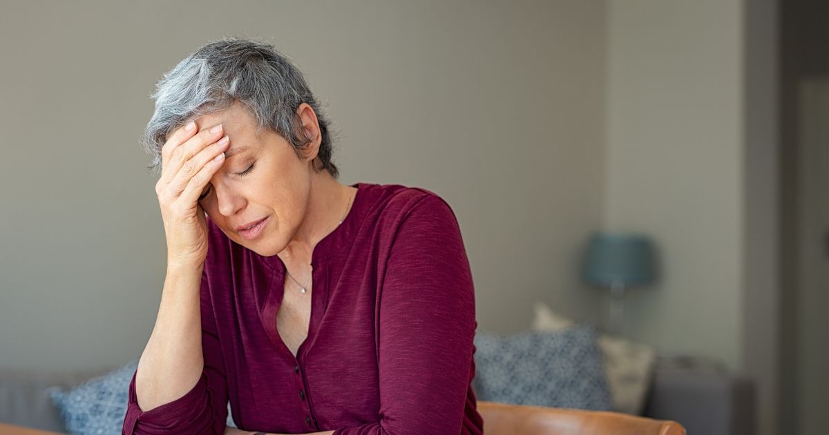 Distressed woman at home reflecting on what BC employees should know before responding to their employer in workplace disputes.
