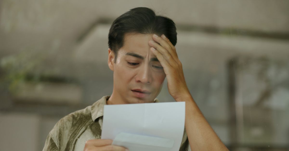 Worried man reading a letter, what Ontario employees should know before responding to their employer about workplace issues.