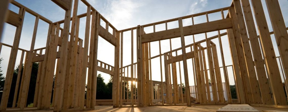 Wooden frame of a house under construction at sunset, representing the construction industry context of the Ramsook v. Polat case.