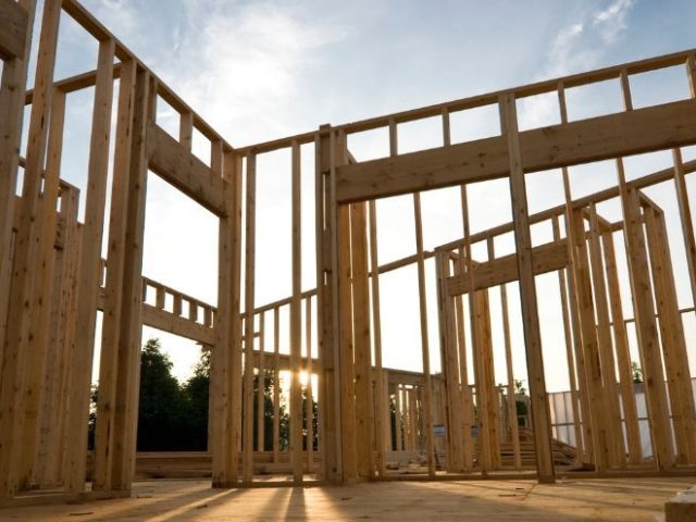 Wooden frame of a house under construction at sunset, representing the construction industry context of the Ramsook v. Polat case.