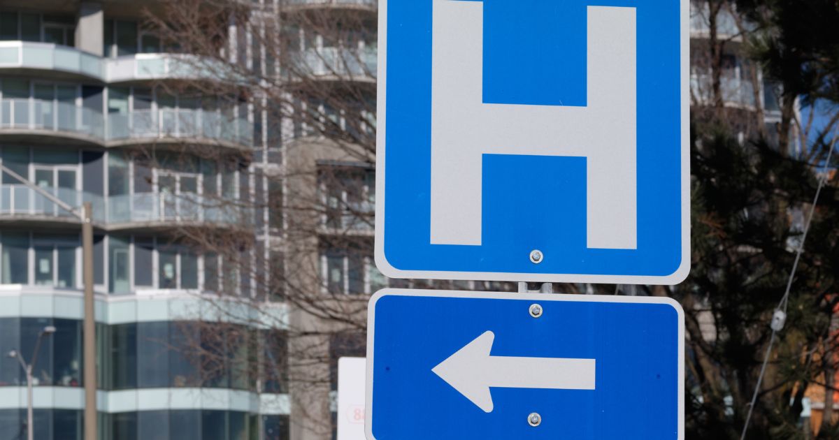 Road sign pointing toward a hospital, illustrating the 2026 Ottawa healthcare layoffs
