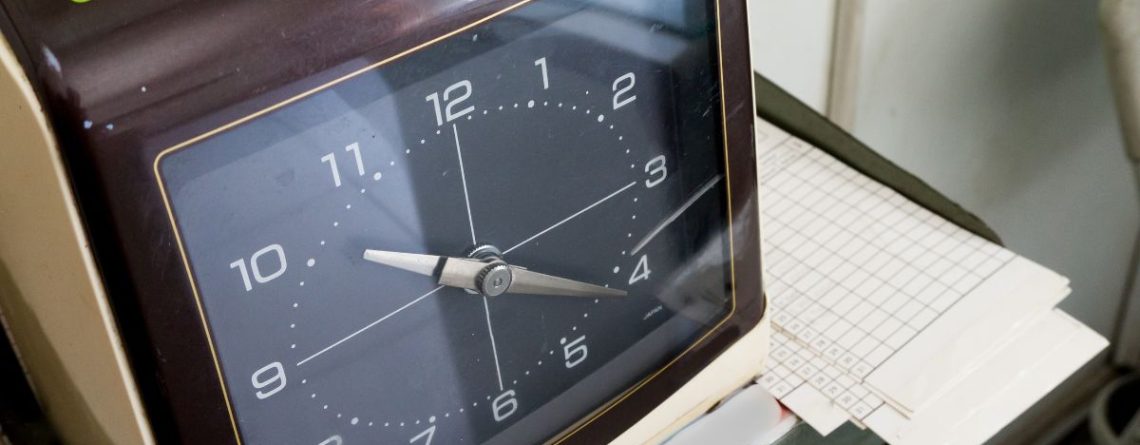 Time sheet and clock representing overtime tracking in the Kinzett overtime and reprisal decision