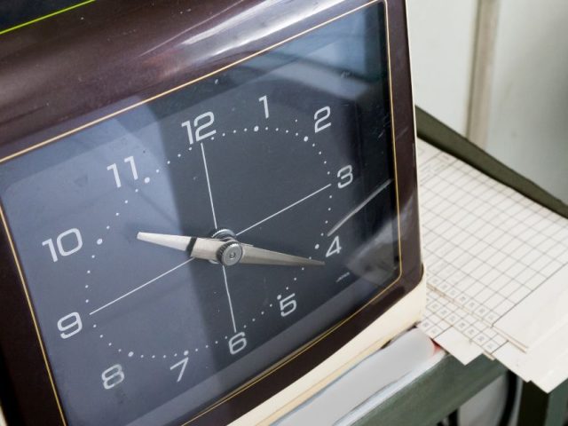 Time sheet and clock representing overtime tracking in the Kinzett overtime and reprisal decision