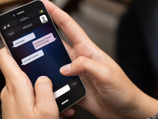 Person reading a private messaging chat on a smartphone, illustrating off-duty conduct in the Metrolinx harassment case