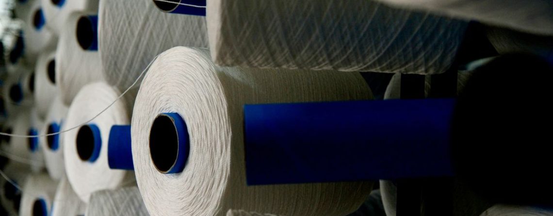 Spools of synthetic fibre at a nylon manufacturing facility, illustrating the INVISTA Kingston plant layoffs