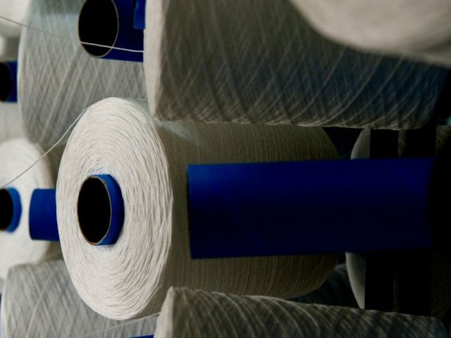 Spools of synthetic fibre at a nylon manufacturing facility, illustrating the INVISTA Kingston plant layoffs