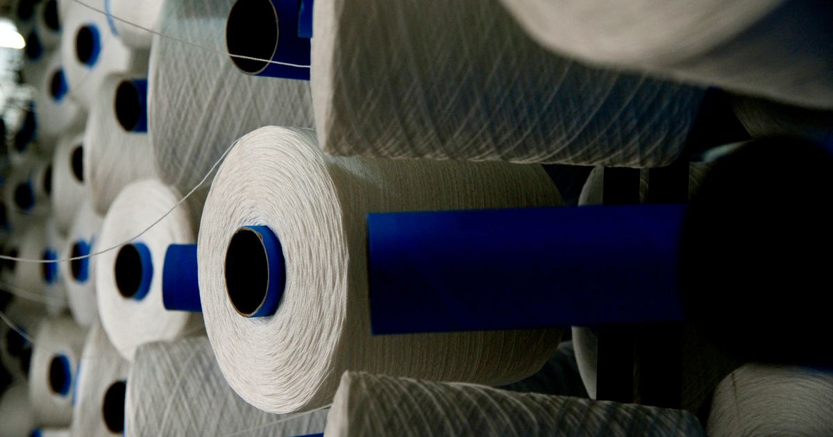 Spools of synthetic fibre at a nylon manufacturing facility, illustrating the INVISTA Kingston plant layoffs